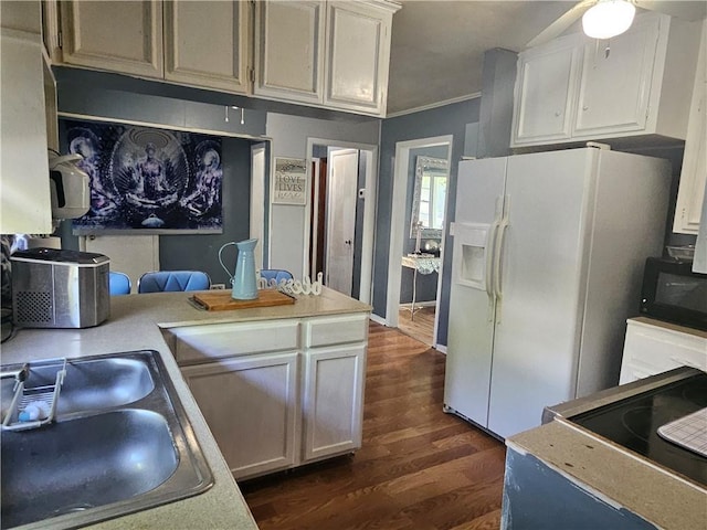 kitchen featuring dark wood-style flooring, black microwave, ceiling fan, a sink, and white fridge with ice dispenser