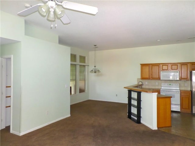 kitchen featuring decorative backsplash, a ceiling fan, pendant lighting, white appliances, and dark carpet