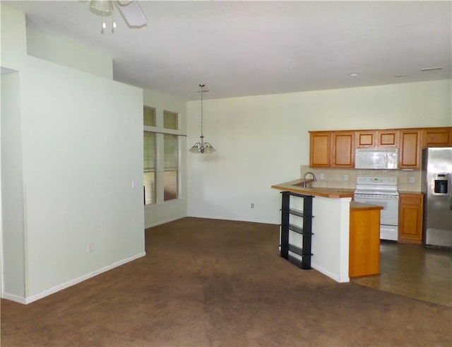 kitchen with white appliances, dark colored carpet, ceiling fan, brown cabinets, and backsplash