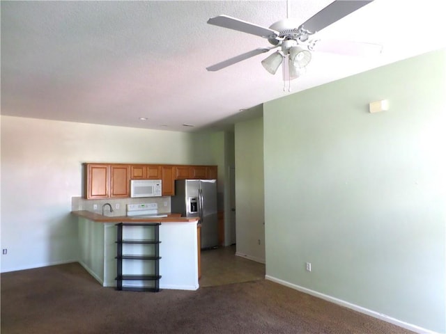 kitchen featuring stainless steel refrigerator with ice dispenser, range, white microwave, a peninsula, and dark carpet
