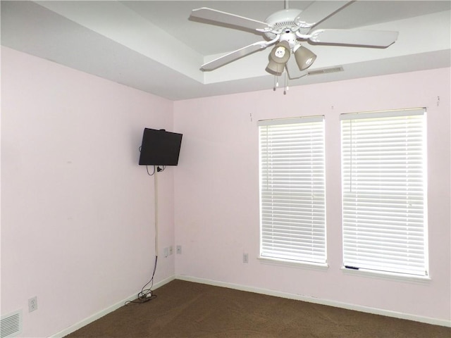 empty room with a ceiling fan, baseboards, visible vents, and carpet floors
