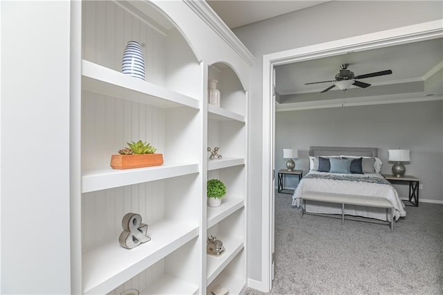 carpeted bedroom featuring ceiling fan and ornamental molding
