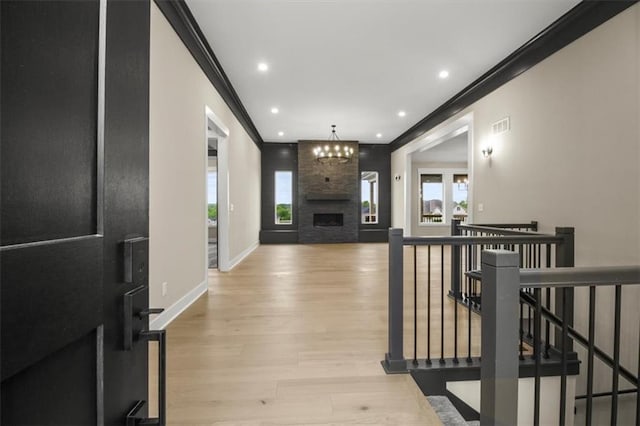 2608 NE Amanda Ln, Blue Springs, MO 64029 - living room with crown molding, wood finished floors, recessed lighting, and a fireplace