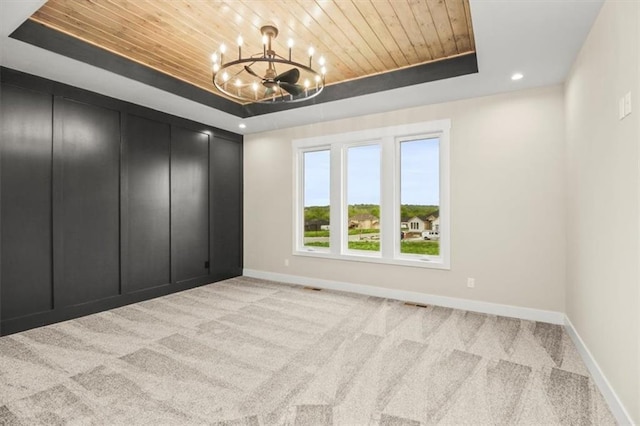 2608 NE Amanda Ln, Blue Springs, MO 64029 - carpeted empty room featuring a raised ceiling, wooden ceiling, a chandelier, and recessed lighting