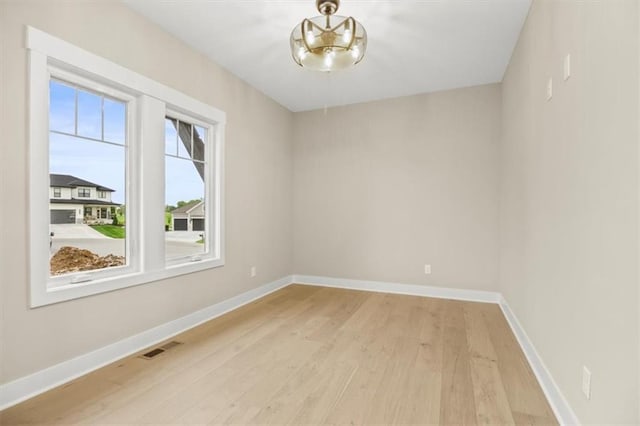 2608 NE Amanda Ln, Blue Springs, MO 64029 - empty room featuring light wood-style floors and baseboards