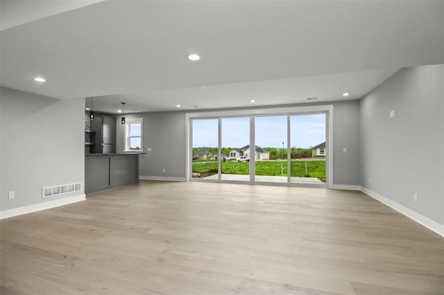 2608 NE Amanda Ln, Blue Springs, MO 64029 - unfurnished living room featuring light wood-style floors and recessed lighting