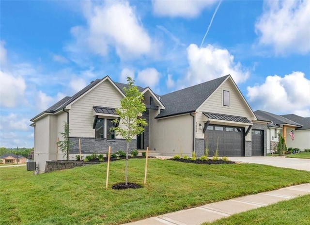 2608 NE Amanda Ln, Blue Springs, MO 64029 - view of front facade featuring driveway, a front lawn, stone siding, and a standing seam roof