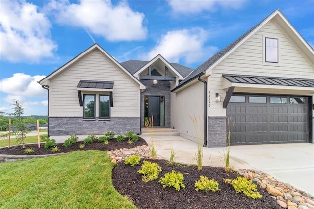 2608 NE Amanda Ln, Blue Springs, MO 64029 - craftsman-style home featuring concrete driveway, stone siding, a garage, and a standing seam roof