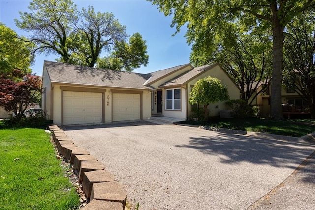 ranch-style home featuring an attached garage, driveway, stucco siding, and central AC unit