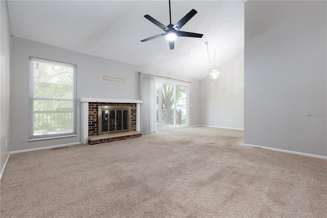 unfurnished living room with a ceiling fan, carpet floors, baseboards, a fireplace, and high vaulted ceiling