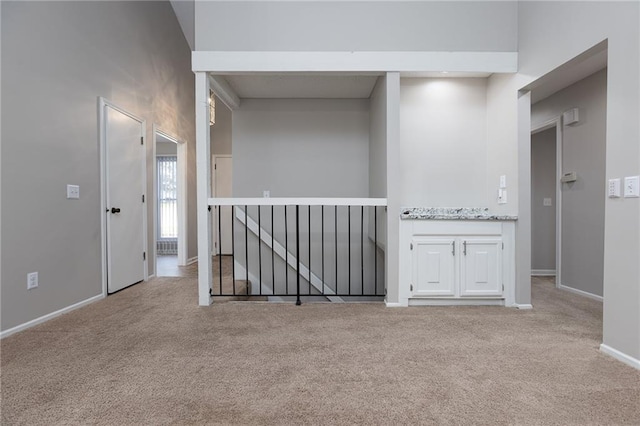 carpeted spare room with baseboards