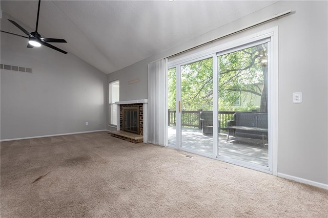 unfurnished living room featuring carpet floors, lofted ceiling, a fireplace, a ceiling fan, and baseboards