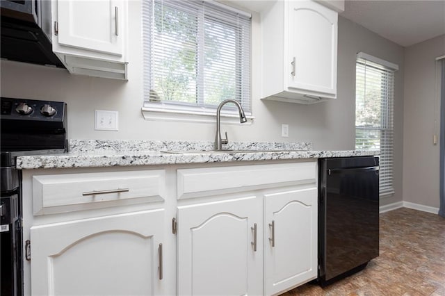 kitchen featuring dishwasher, electric range oven, white cabinets, and a sink
