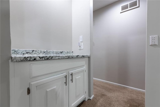 detailed view of carpet floors and baseboards