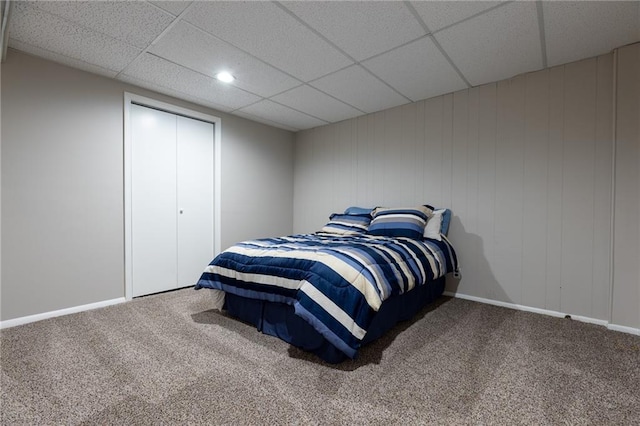 carpeted bedroom featuring baseboards, a paneled ceiling, and recessed lighting