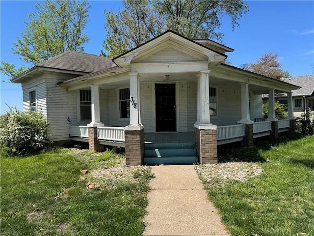 318 S Williams St, Craig, MO 64437 - bungalow-style house featuring a porch, roof with shingles, and a front yard