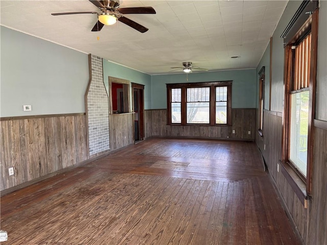 318 S Williams St, Craig, MO 64437 - empty room with wood-type flooring, a ceiling fan, and wainscoting