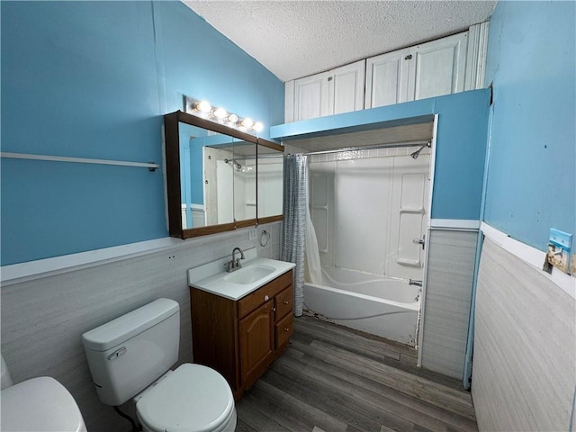 318 S Williams St, Craig, MO 64437 - bathroom featuring vanity, toilet, a textured ceiling, shower / bath combo with shower curtain, and wood finished floors