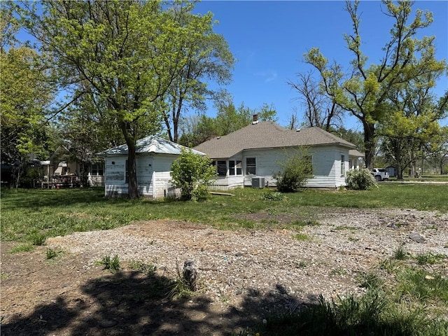 318 S Williams St, Craig, MO 64437 - back of house featuring a lawn and central AC unit