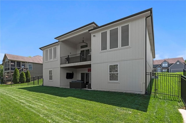 rear view of house featuring a balcony and an outdoor living space