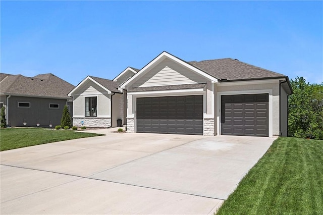 view of front of property with an attached garage, driveway, a front lawn, and stone siding