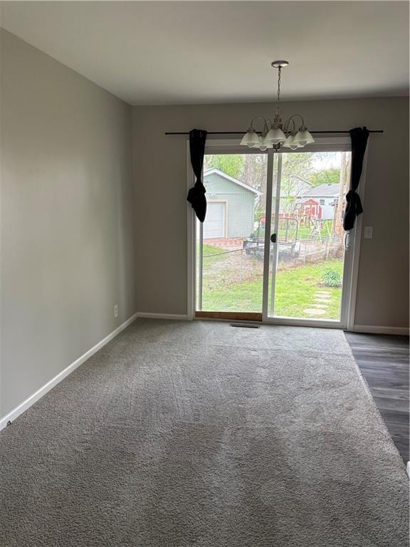 unfurnished dining area featuring baseboards, a chandelier, and a healthy amount of sunlight