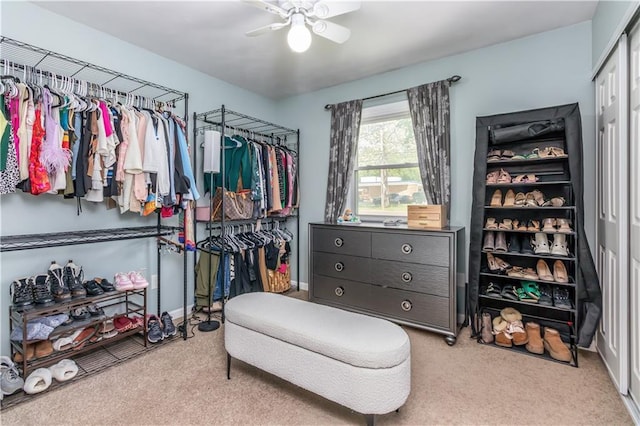 walk in closet with carpet flooring and a ceiling fan
