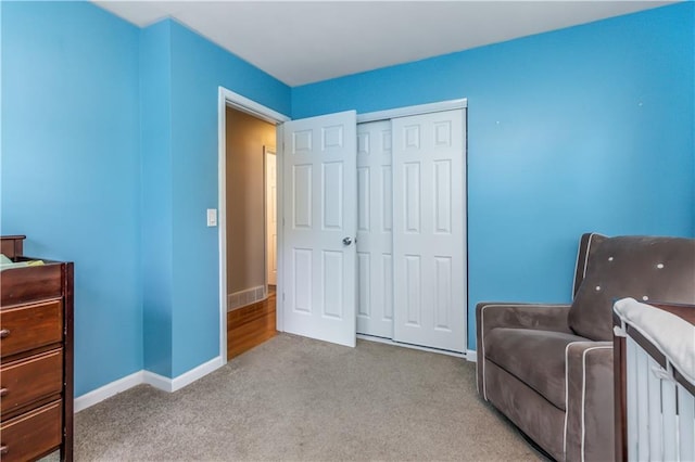 sitting room featuring baseboards and carpet flooring
