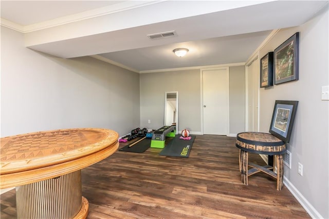 playroom featuring crown molding, wood finished floors, and visible vents