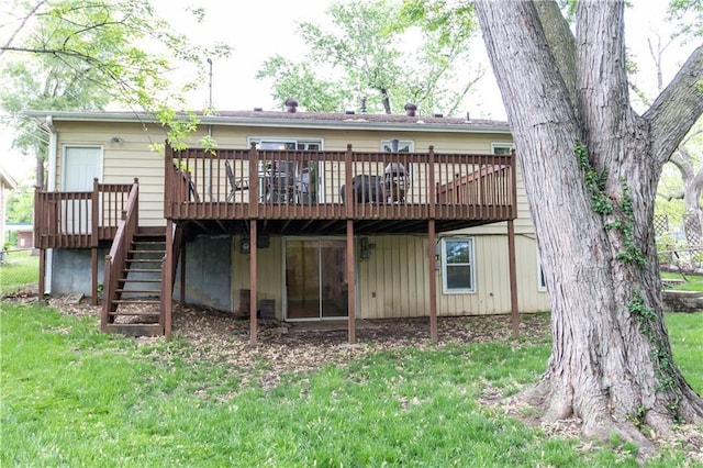 back of property featuring stairway, a deck, and a lawn