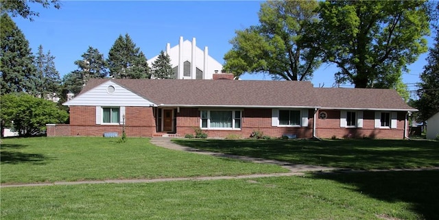 109 N 2nd St, Hiawatha, KS 66434 - ranch-style house featuring brick siding, a front lawn, and a chimney
