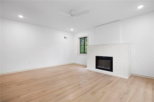 1639 Indiana St, Lawrence, KS 66044 - unfurnished living room featuring light wood-style flooring, a ceiling fan, a tile fireplace, recessed lighting, and baseboards