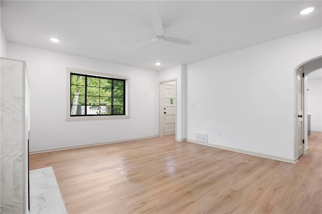 1639 Indiana St, Lawrence, KS 66044 - empty room featuring arched walkways, light wood-type flooring, a ceiling fan, recessed lighting, and baseboards