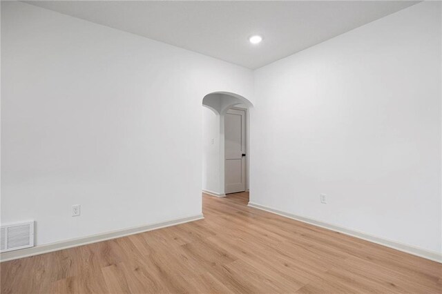 1639 Indiana St, Lawrence, KS 66044 - unfurnished room featuring arched walkways, light wood-style flooring, baseboards, and recessed lighting