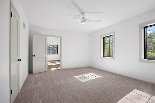 1639 Indiana St, Lawrence, KS 66044 - unfurnished bedroom featuring carpet and a ceiling fan