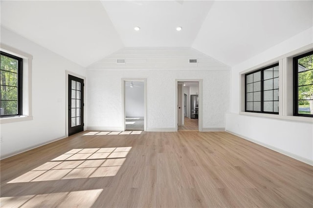 1639 Indiana St, Lawrence, KS 66044 - unfurnished bedroom with vaulted ceiling, multiple windows, and wood finished floors