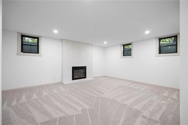 1639 Indiana St, Lawrence, KS 66044 - basement featuring carpet flooring, a tile fireplace, recessed lighting, and plenty of natural light