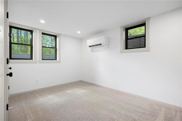1639 Indiana St, Lawrence, KS 66044 - spare room featuring a wall mounted AC, carpet, recessed lighting, and baseboards