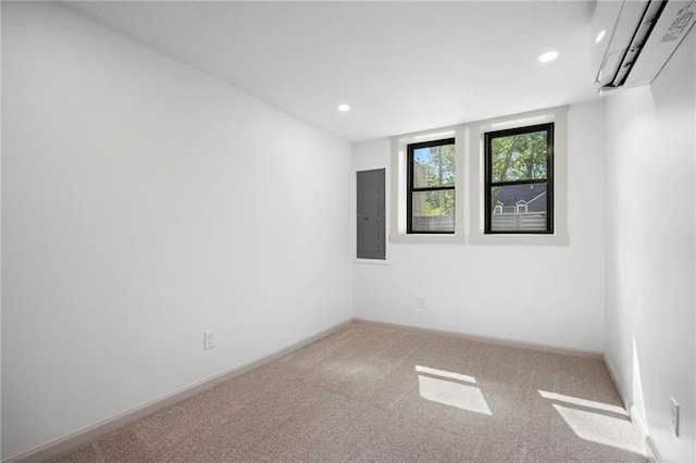 1639 Indiana St, Lawrence, KS 66044 - carpeted empty room with electric panel, a wall unit AC, baseboards, and recessed lighting