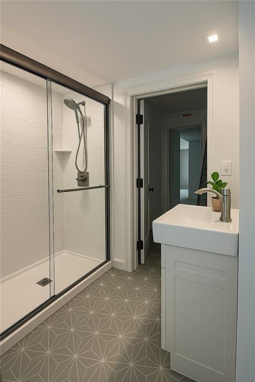 1639 Indiana St, Lawrence, KS 66044 - full bathroom featuring a stall shower, vanity, and tile patterned floors