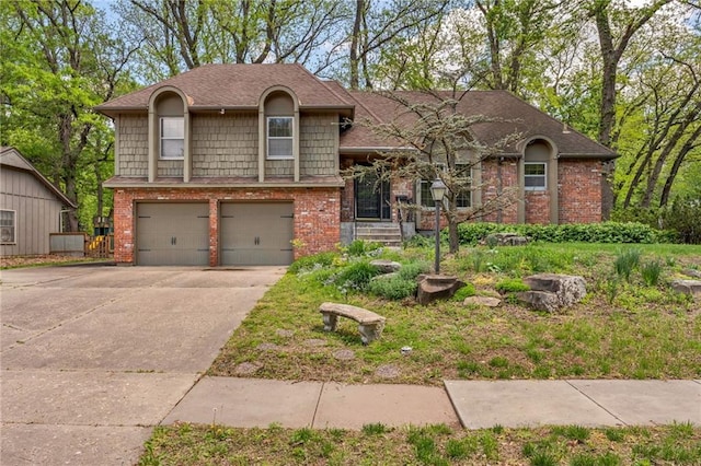 split level home with an attached garage, driveway, and brick siding