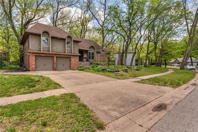 view of front of property with an attached garage, concrete driveway, a front yard, and brick siding