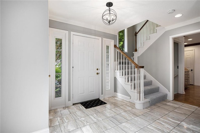 foyer with stairs, a chandelier, baseboards, crown molding, and recessed lighting