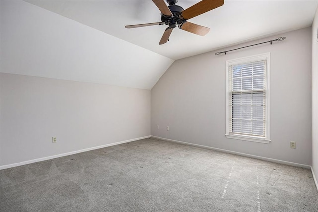 additional living space with carpet floors, lofted ceiling, baseboards, and a ceiling fan