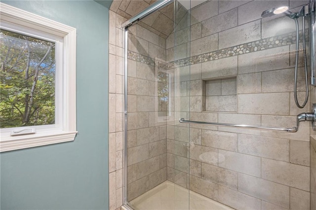 full bathroom featuring a stall shower and plenty of natural light