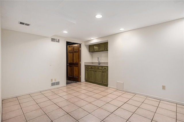 unfurnished room with recessed lighting, baseboards, and light tile patterned floors