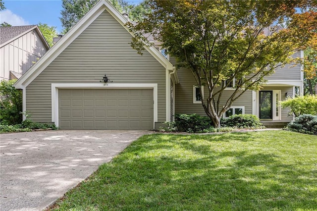 view of front of house featuring an attached garage, concrete driveway, a front lawn, and board and batten siding