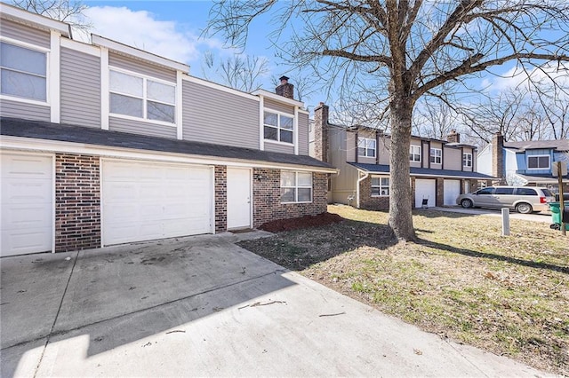 townhome / multi-family property featuring a residential view, an attached garage, brick siding, a chimney, and concrete driveway