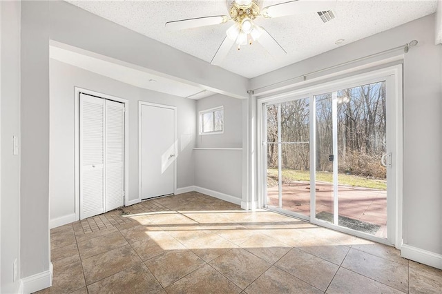unfurnished bedroom featuring access to outside, baseboards, and multiple windows