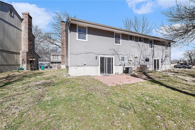 rear view of property featuring a yard, a patio, and central air condition unit